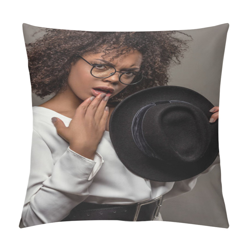 Personality  Young Perplexed African American Woman In White Shirt Wearing Glasses And Holding Hat Isolated On Grey Background Pillow Covers