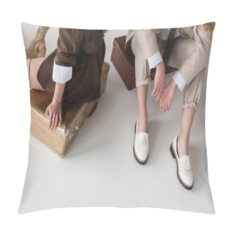 Personality  Cropped View Of Young Women Sitting On Travel Bags On White  Pillow Covers