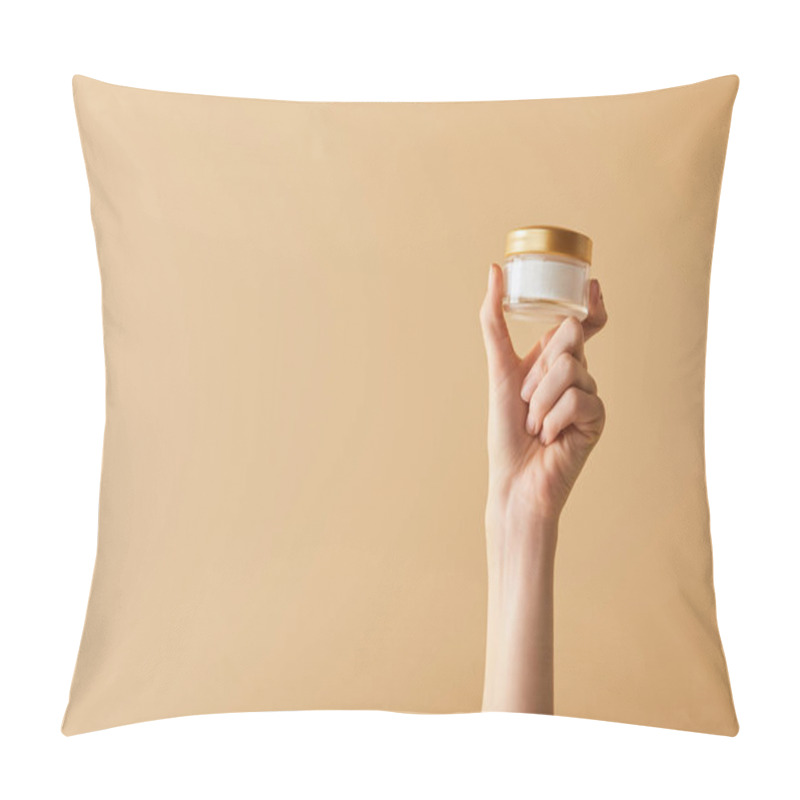 Personality  Cropped View Of Female Hand Holding Cosmetic Cream On Beige Background Pillow Covers