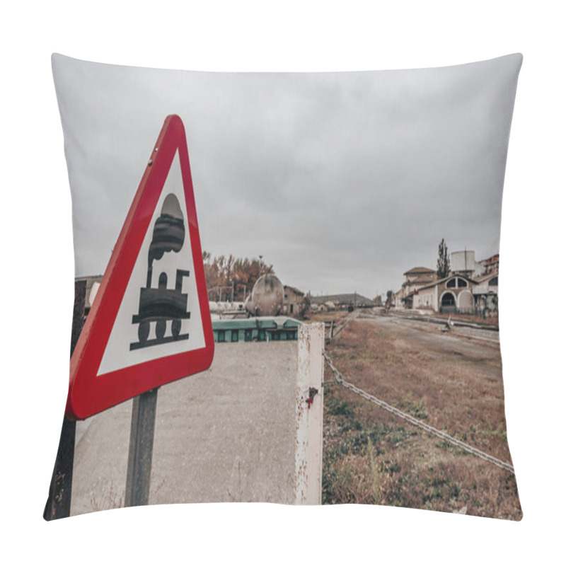 Personality  Railway Crossing Sign In Rural Station. Close-up Of A Triangular Railway Crossing Sign With A Rustic, Rural Station In The Background On A Cloudy Day, Evoking Caution And Nostalgia. Pillow Covers