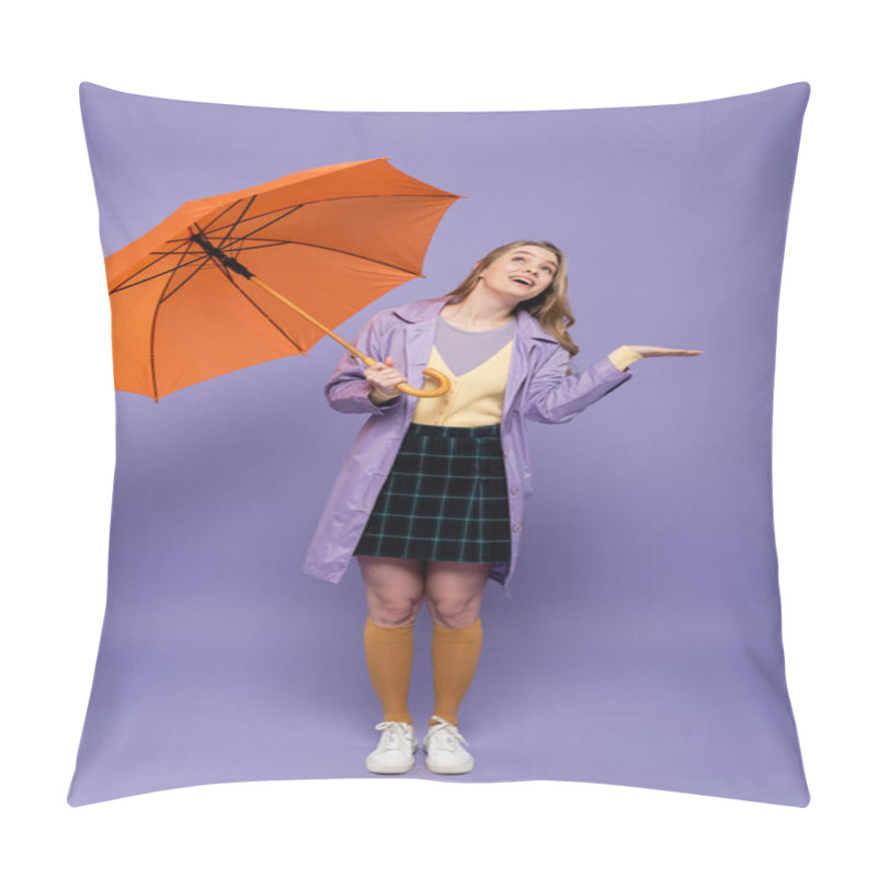 Personality  Full Length Of Cheerful Young Woman In Trench Coat Gesturing While Holding Orange Umbrella On Purple  Pillow Covers