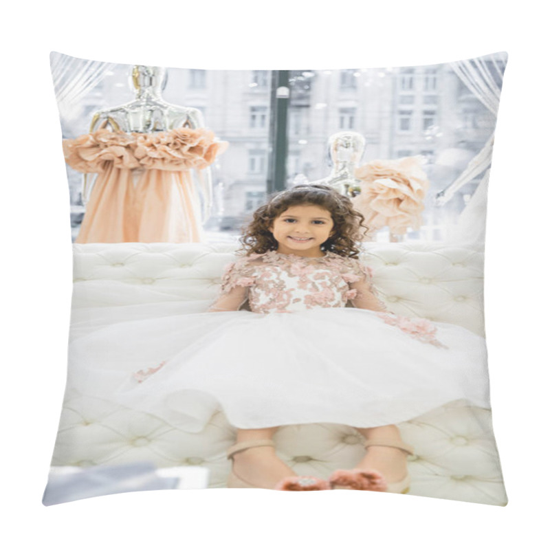 Personality  Cheerful Middle Eastern Girl With Curly Hair Sitting In Floral Dress On White Couch Inside Of Luxurious Wedding Salon, Smiling Kid, Tulle Skirt, Bridal, Blurred Mannequin On Background  Pillow Covers