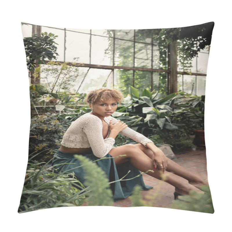 Personality  Young And Trendy African American Woman In Knitted Top And Skirt Looking At Camera And Touching Shoulder While Sitting Near Plants In Orangery, Fashionable Woman Enjoying Summer Vibes Pillow Covers