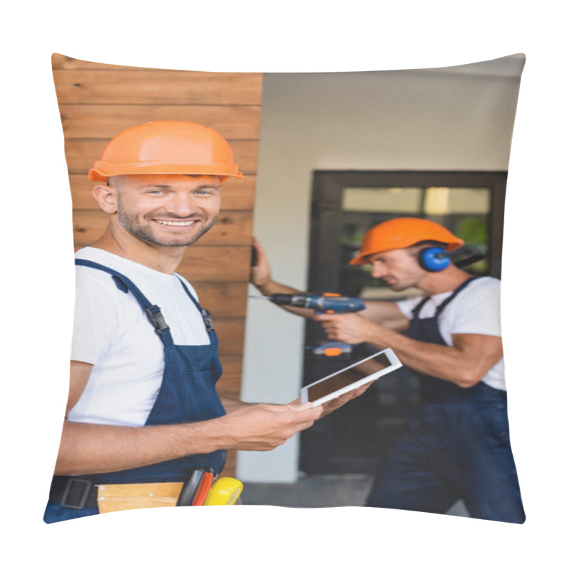 Personality  Selective Focus Of Builder Holding Digital Tablet Near Colleague Working With Electric Screwdriver On Facade Of Building  Pillow Covers