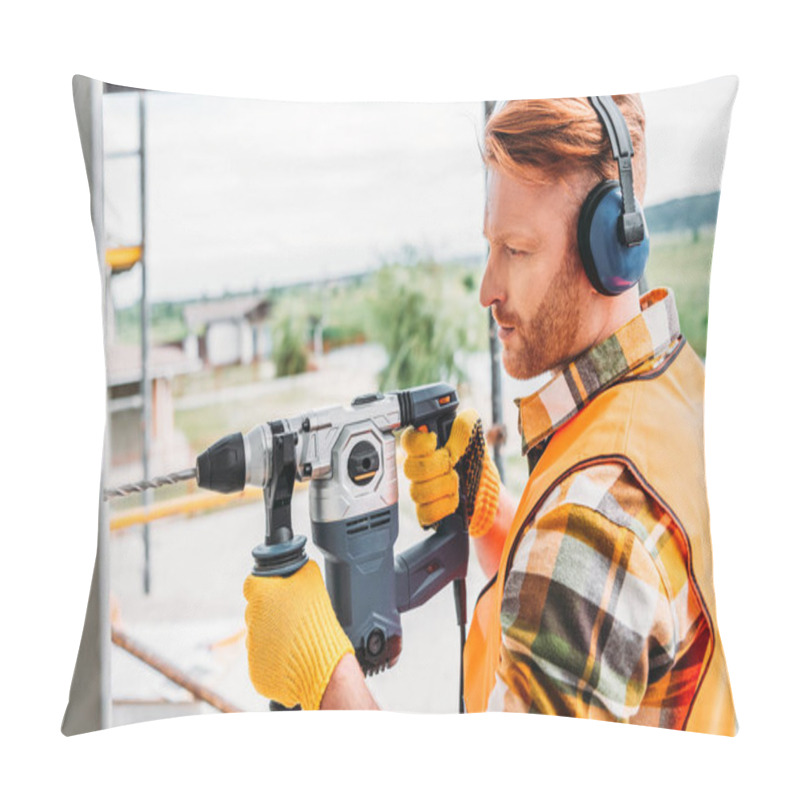 Personality  Side View Of Handsome Builder In Noise Reducing Headphones Using Power Drill At Construction Site Pillow Covers