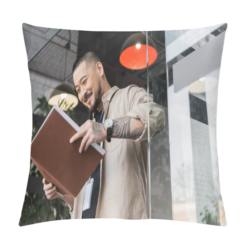 Personality  Happy Asian Businessman With Tattoo Looking At Documents Inside Of Folder Near Glass Door, Low Angle Pillow Covers