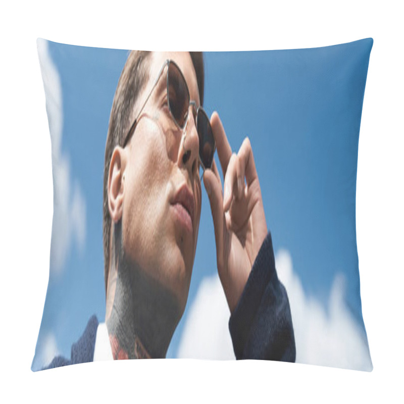 Personality  Tattooed Man Looks Up At The Sky, Adjusting His Sunglasses Against A Bright Blue Background. Pillow Covers