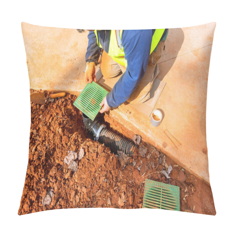 Personality  Construction Worker Wearing Safety Vest Is Installing Drainage Grates Over Pipes In Trench Ground Around Is Covered With Red Soil, Debris, Indicating Ongoing Work. Pillow Covers