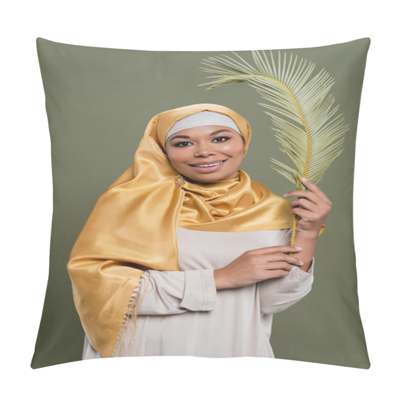 Personality  Cheerful Multiracial Woman In Yellow Silk Hijab Holding Leaf Of Exotic Plant And Smiling At Camera Isolated On Green Pillow Covers