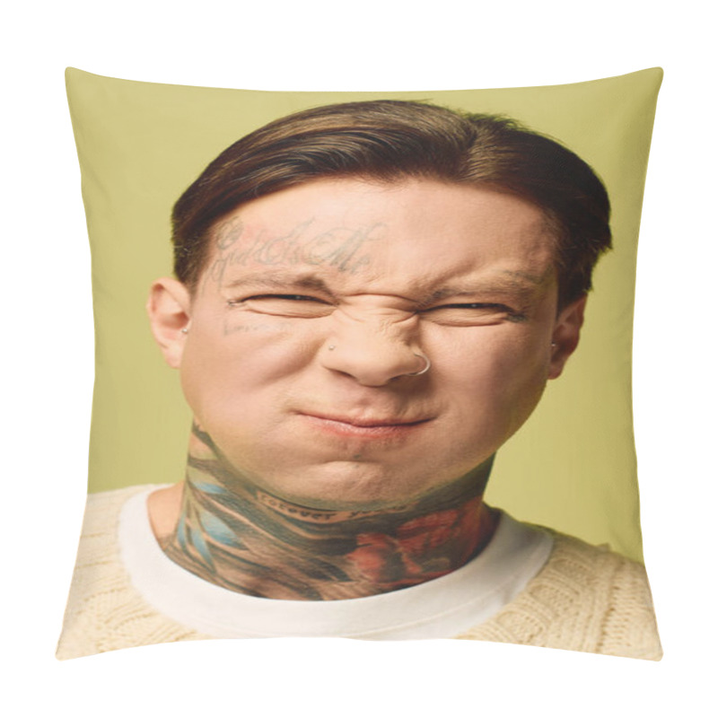 Personality  A Tattooed Young Man Playfully Scrunches His Face, His Ink Vivid Against A Green Backdrop. Pillow Covers