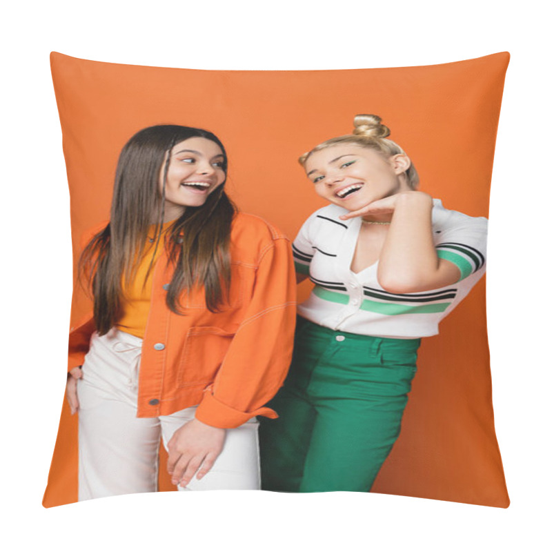 Personality  Cheerful And Trendy Brunette Teenager With Bright Makeup Looking At Blonde Friend Holding Hand Near Face While Posing On Orange Background, Fashionable Girls With Sense Of Style Pillow Covers