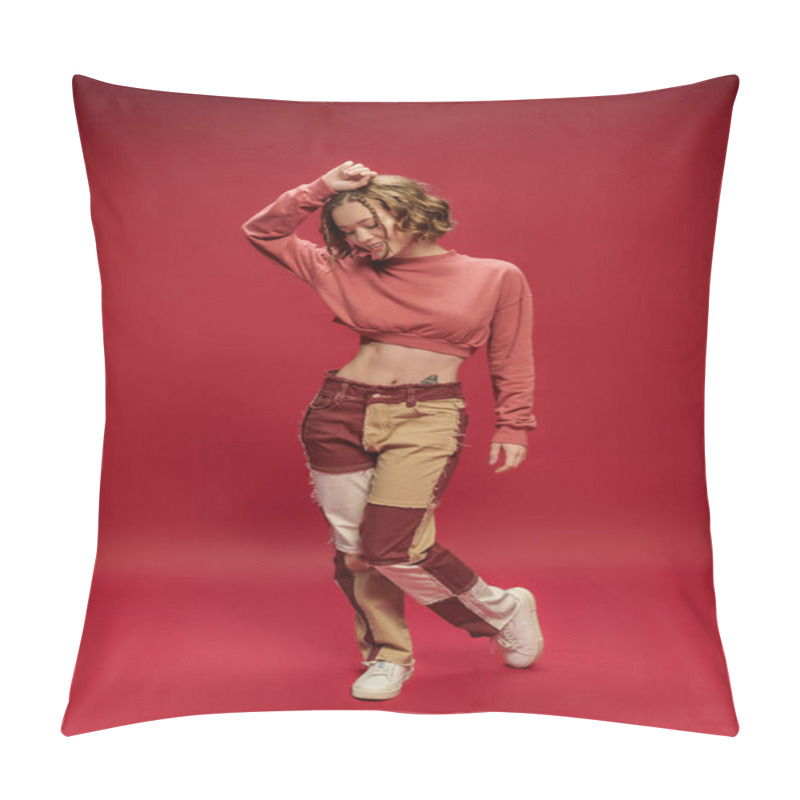 Personality  Happy Stylish And Young Woman In Patchwork Pants And Cropped Long Sleeve Posing On Red Backdrop Pillow Covers