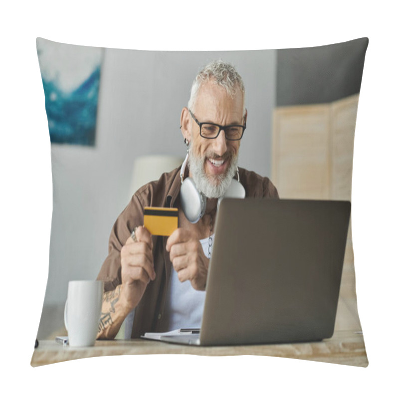 Personality  A Mature Gay Man With Tattoos And Grey Hair Smiles As He Shops Online With A Credit Card, Working Remotely From Home. Pillow Covers