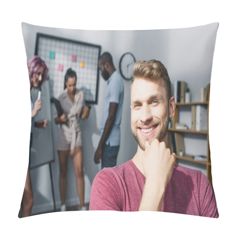 Personality  Businessman With Hand Near Chin Looking At Camera While Multicultural Coworkers Working In Office At Background  Pillow Covers