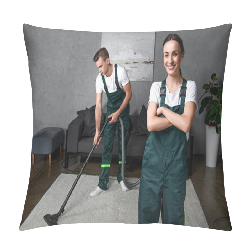 Personality  Young Male Cleaner Using Vacuum Cleaner And Female Coworker Standing With Crossed Arms And Smiling At Camera Pillow Covers