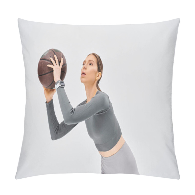 Personality  A Sporty Young Woman Gracefully Holds A Basketball In Her Right Hand Against A Neutral Grey Background. Pillow Covers