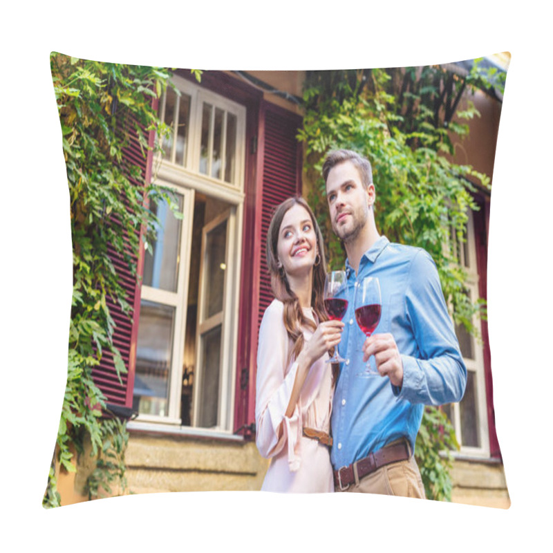 Personality  Happy Couple Holding Glasses Of Red Wine While Standing Near House Covered With Green Ivy And Looking Away Pillow Covers