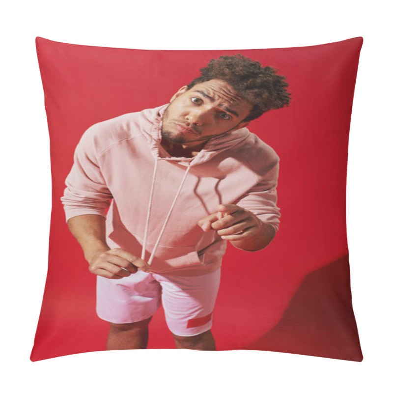 Personality  African American Man Pulling Drawstrings Of Pink Hoodie And Looking At Camera On Red Background Pillow Covers