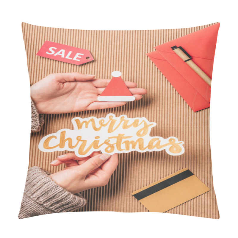 Personality  Cropped Image Of Woman Holding Merry Christmas Lettering And Santa Hat Over Surface With Credit Card And Sale  Pillow Covers