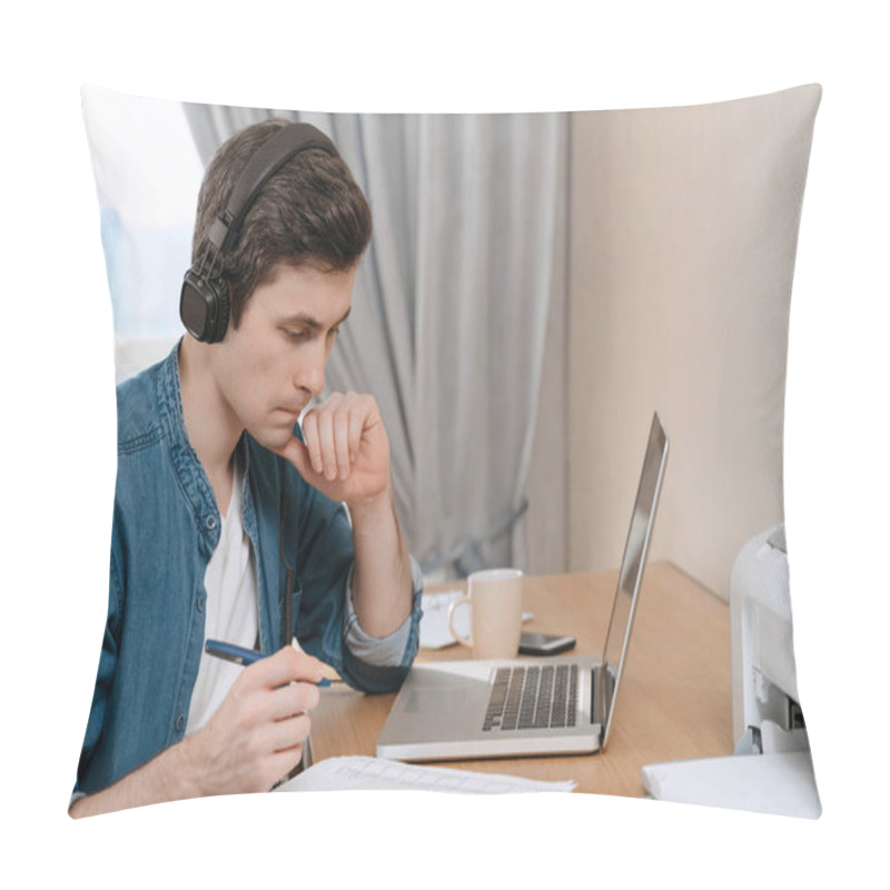 Personality  Hard-working Serious Man Freelancer In Headphones Looking Concentrated At Documents And Holding A Pan. Young Businessman Using Laptop Software For Work Tasks, Thinking About Solution Of Work Problems Pillow Covers