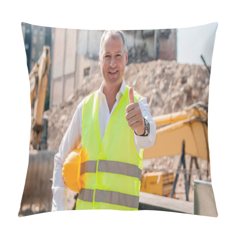 Personality  Portrait Of Smiling Civil Engineer Holding Hardhat And Showing Thumb Up Gesture On Construction Site Pillow Covers