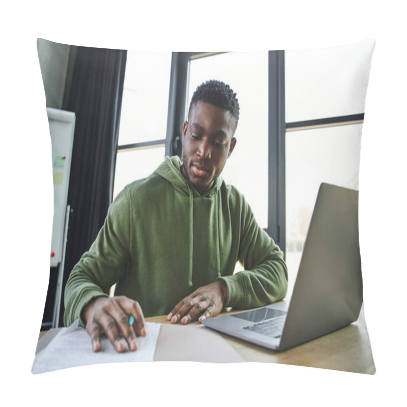 Personality  Young And Stylish African American Businessman Sitting At Workplace And Working With Documents Near Laptop And Flip Chart On Blurred Background In Office, Ambitious And Career Oriented Youth Pillow Covers