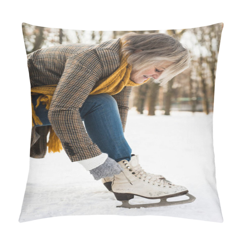 Personality  Senior Woman In Winter Clothes Putting On Old Ice Skates. Pillow Covers