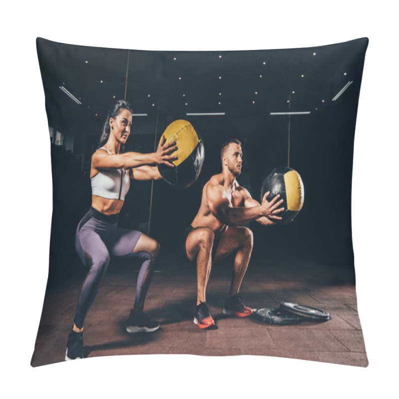 Personality  Athletic Sportsman And Sportswoman Doing Squats With Medicine Balls Together In Dark Gym Pillow Covers