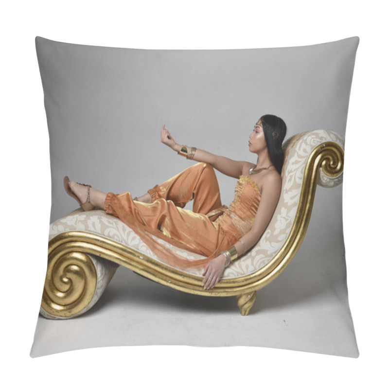 Personality  Full Length Portrait Of Pretty Young Asian Woman Wearing Golden Arabian Robes Like A Genie, Seated Pose On Lounge, Isolated On Studio Background. Pillow Covers