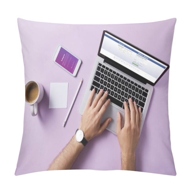 Personality  Cropped Shot Of Man Using Laptop With Facebook Website On Screen And Instagram App In Smartphone At Workplace On Pink Surface Pillow Covers