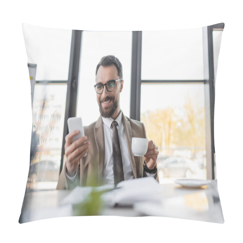 Personality  Ambitious Corporate Manager In Beige Stylish Blazer, Eyeglasses And Tie Holding Coffee Cup And Looking At Mobile Phone While Smiling Near Notebook, Saucer And Computer On Blurred Foreground Pillow Covers