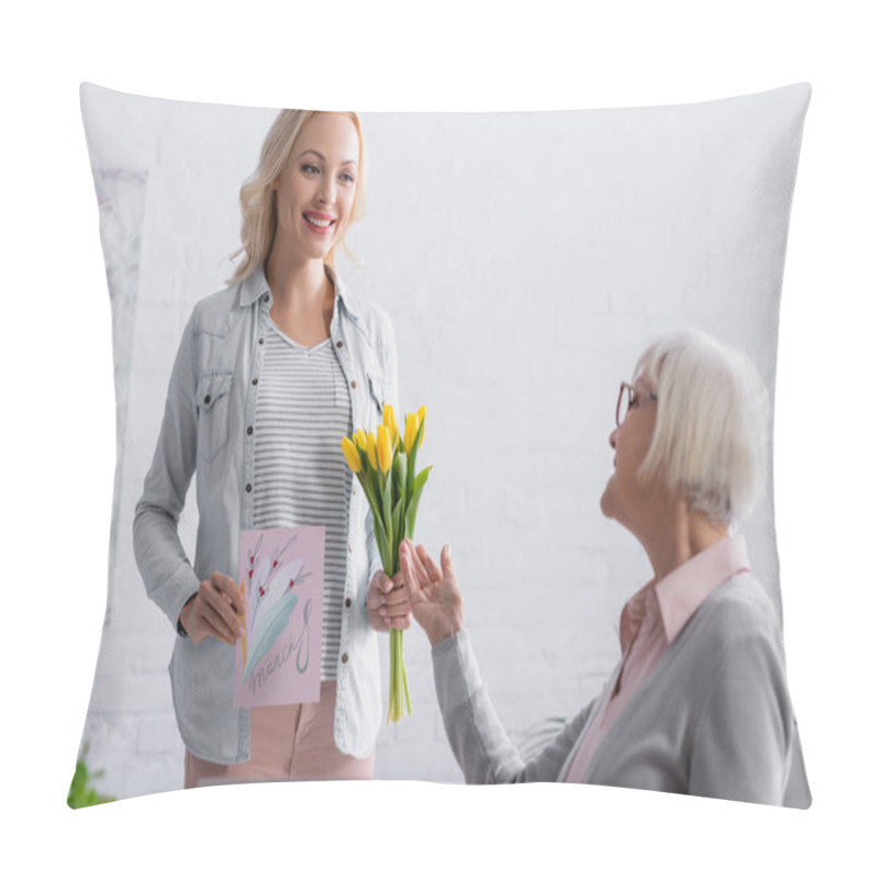 Personality  Cheerful Woman Holding Greeting Card And Tulips Near Elderly Mother On Blurred Foreground  Pillow Covers