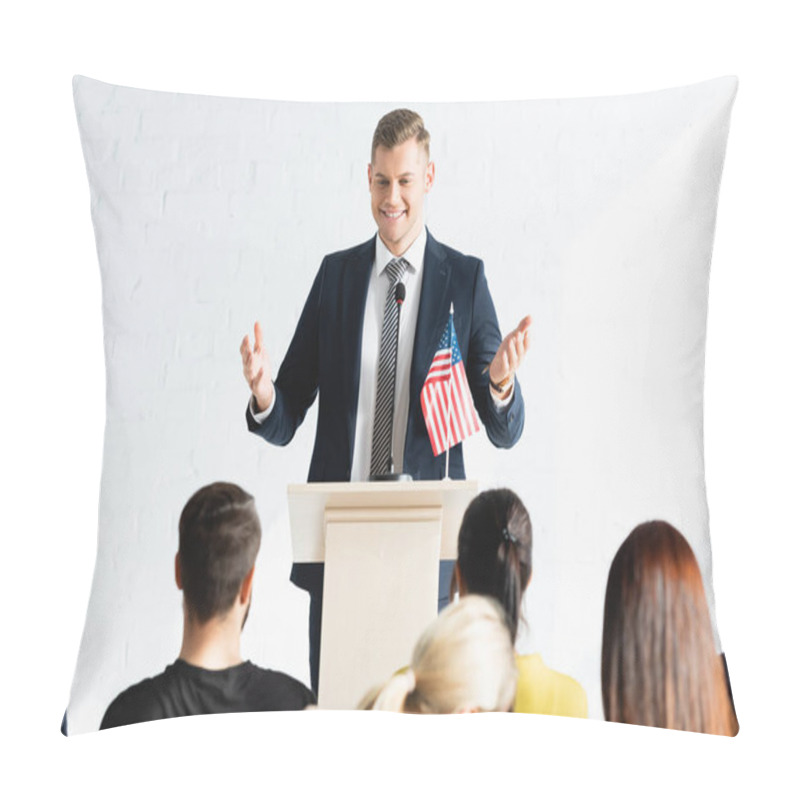 Personality  Smiling Speaker Standing With Open Arms In Front Of Voters In Conference Hall, Blurred Foreground Pillow Covers