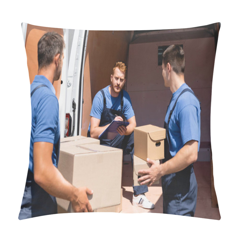 Personality  Selective Focus Of Loader Writing On Clipboard Near Colleagues Holding Carton Packages Outdoors Pillow Covers