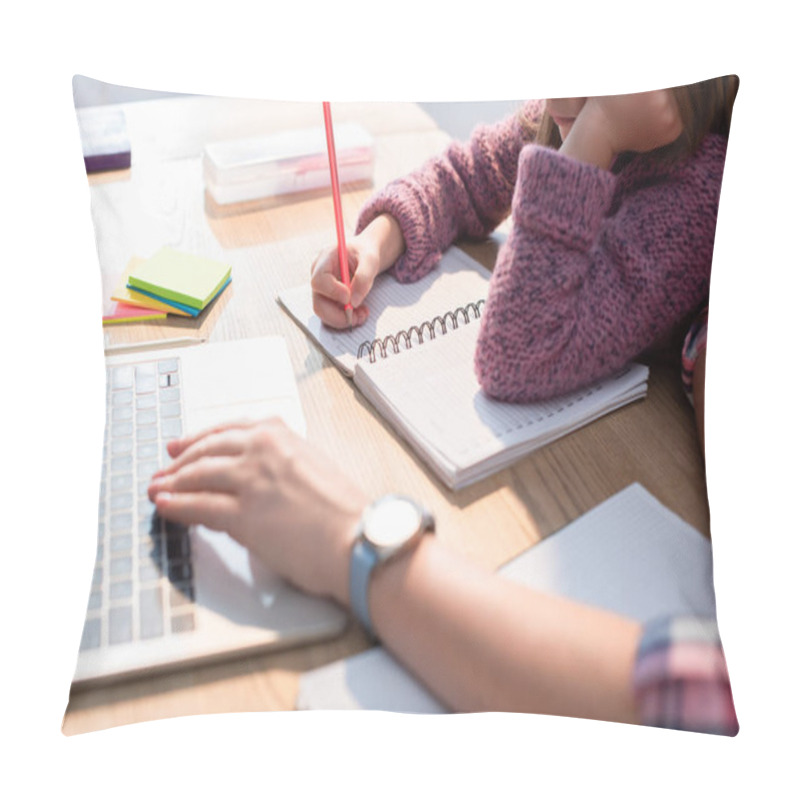 Personality  Cropped View Of Daughter Writing In Notebook At Desk With Blurred Mother Typing On Laptop On Foreground Pillow Covers