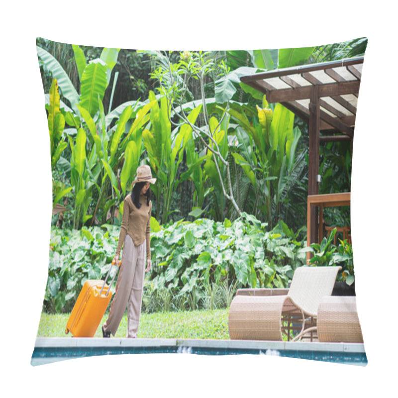 Personality  A Woman Walking By A Poolside With An Orange Suitcase, Wearing A Hat And Stylish Outfit. The Background Features Lush Greenery And A Wooden Structure, Creating A Tropical Vacation Vibe. Pillow Covers