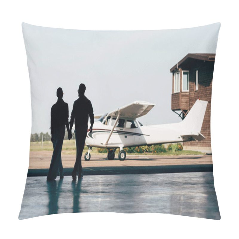 Personality  Rear View Of Silhouettes Of Stylish Couple Holding Hands And Walking In Hangar Near Airplane Pillow Covers