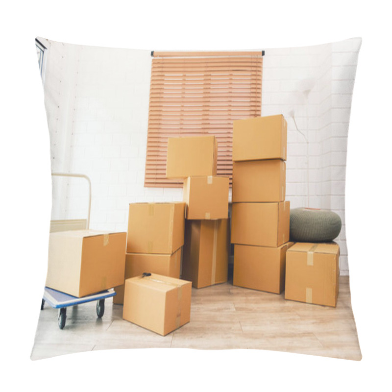 Personality  Boxes And Parcels Are Stacked In The Living Room With A White Wall And Wooden Floor Of The New House. Packed Household Stuff For Moving Into The New House. Home Moving Day Concept. No People In Image. Pillow Covers