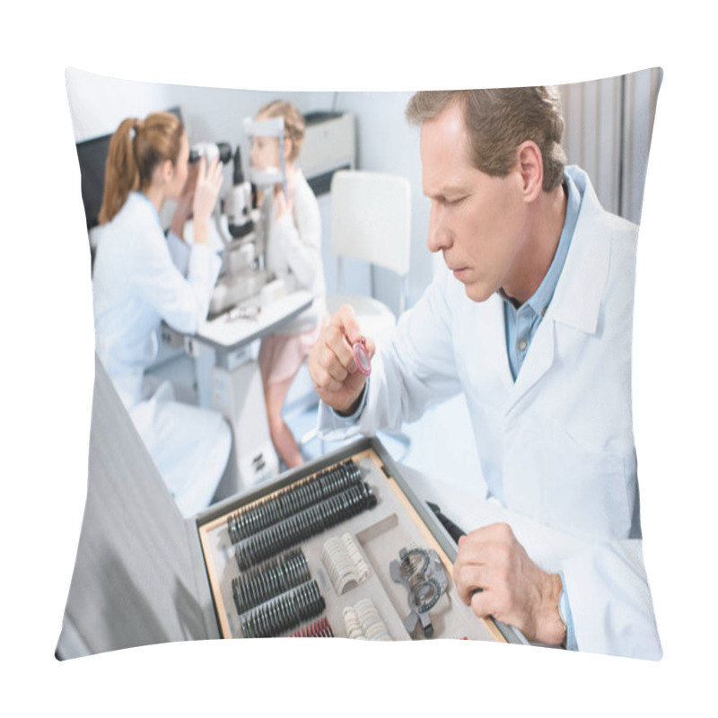 Personality  Male Oculist Holding Lenses For Trial Frame While Colleague Examining Kid With Visual Field Test Pillow Covers