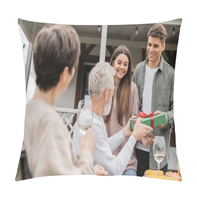 Personality  Smiling Siblings Giving Gift Box To Blurred Middle Aged Parents With Wine Near Food During Barbeque Party And Parents Day Celebration At Backyard In June, Celebrating Parenthood Day Concept Pillow Covers