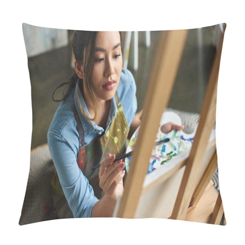 Personality  A Young Asian Artist, Wearing An Apron, Paints On A Canvas In Her Workshop. Pillow Covers