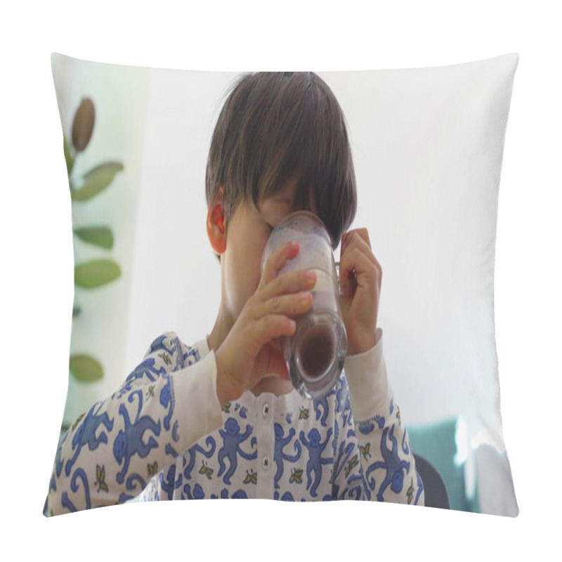 Personality  Young Boy Drinking A Glass Of Chocolate Milk At The Table, Enjoying A Quiet Moment In A Bright Home Kitchen, Wearing Pajamas With Playful Blue Patterns, Relaxed Morning Routine Pillow Covers