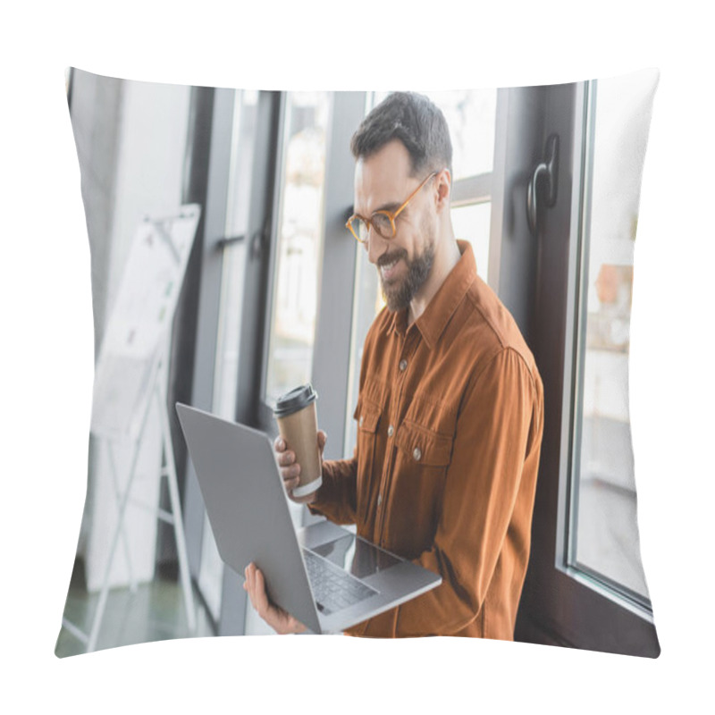 Personality  Brunette And Bearded Businessman In Eyeglasses And Stylish Shirt Holding Disposable Cup With Coffee And Looking At Laptop Near Flip Chart On Blurred Background In Office Pillow Covers