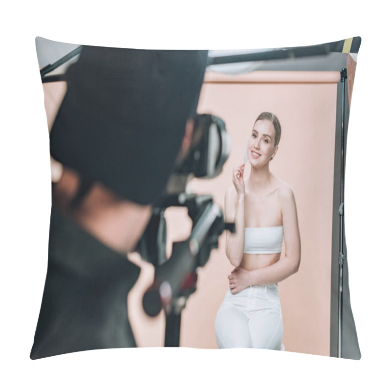 Personality  Selective Focus Of Attractive Model Holding Feather And Smiling To Videographer In Photo Studio Pillow Covers