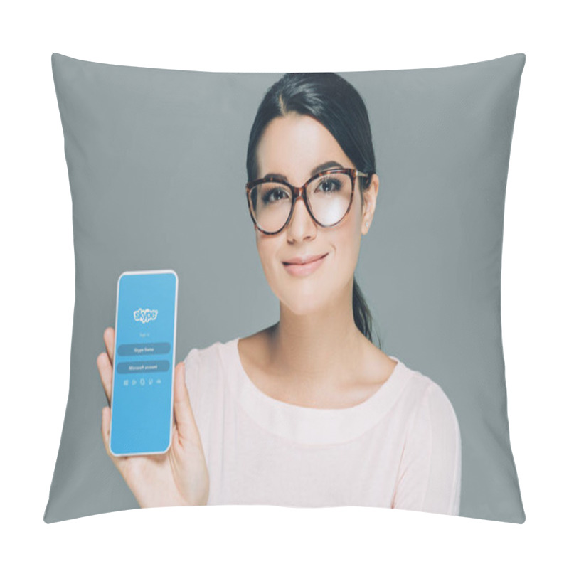 Personality  Portrait Of Smiling Woman In Eyeglasses Showing Smartphone With Skype App On Screen Isolated On Grey Pillow Covers