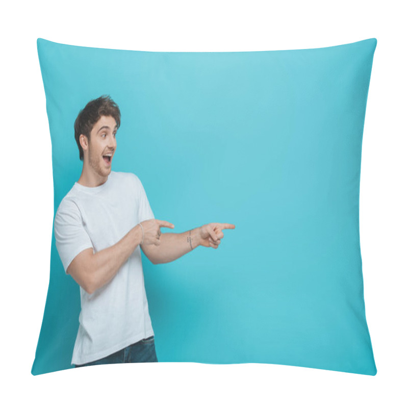 Personality  Cheerful Young Man Pointing With Fingers While Looking Away On Blue Background Pillow Covers