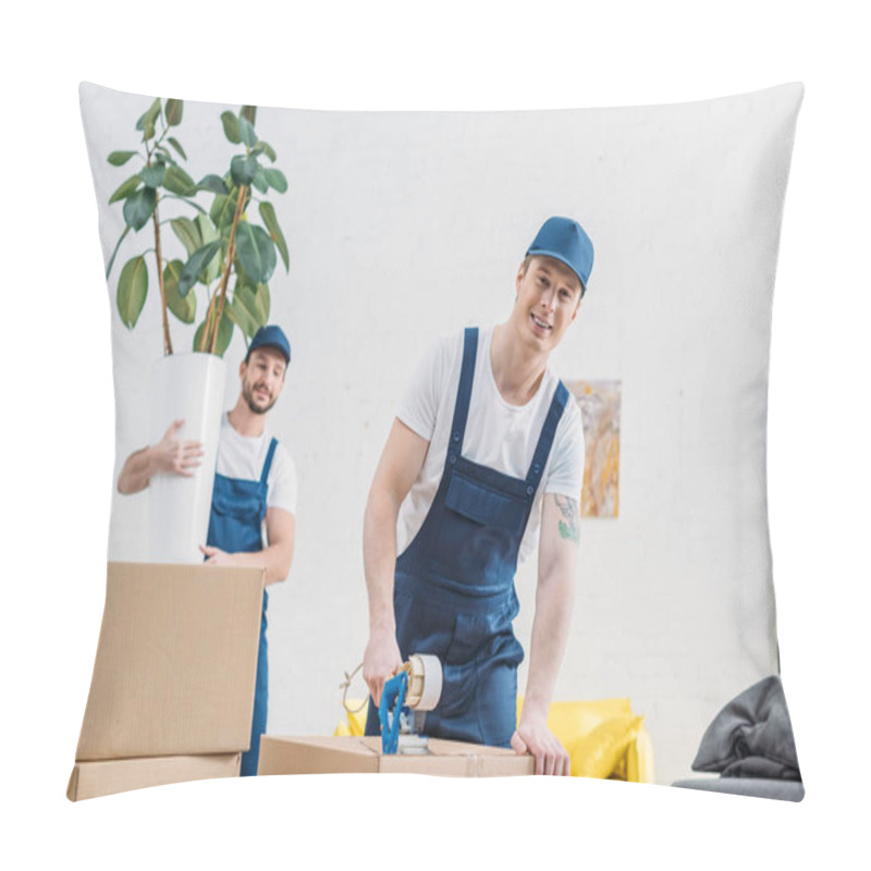 Personality  Mover Holding Plant And Looking At Colleague Wrapping Cardboard Box With Scotch Tape In Apartment Pillow Covers