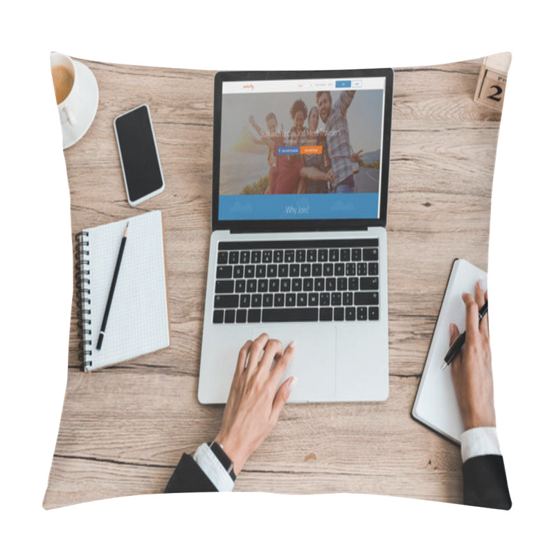 Personality  KYIV, UKRAINE - JULY 23, 2019: Top View Of Woman Using Laptop With Couchsurfing Website Near Smartphone With Blank Screen Pillow Covers