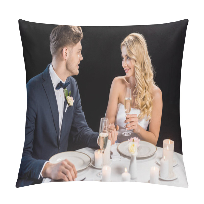 Personality  Happy Young Couple Sitting At Served Table With Glasses Of Champagne And Looking At Each Other Isolated On Black Pillow Covers