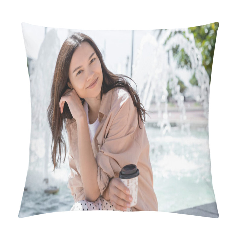 Personality  Smiling Woman In Beige Shirt Holding Coffee To Go And Smiling At Camera Near Blurred Fountain Pillow Covers